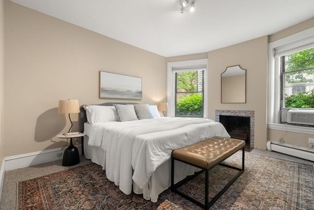 48 Kent St Unit 1, Brookline, MA 02445 - carpeted bedroom with cooling unit, baseboards, a fireplace with flush hearth, and a baseboard radiator