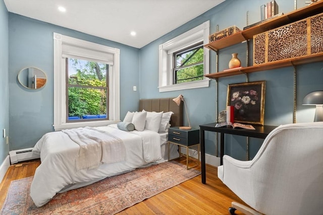 48 Kent St Unit 1, Brookline, MA 02445 - bedroom with multiple windows, a baseboard radiator, wood finished floors, baseboards, and recessed lighting