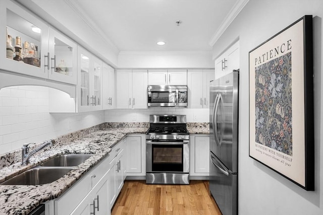 100 Burrill St Unit 3, Swampscott, MA 01907 - kitchen featuring appliances with stainless steel finishes, a sink, crown molding, white cabinets, and recessed lighting