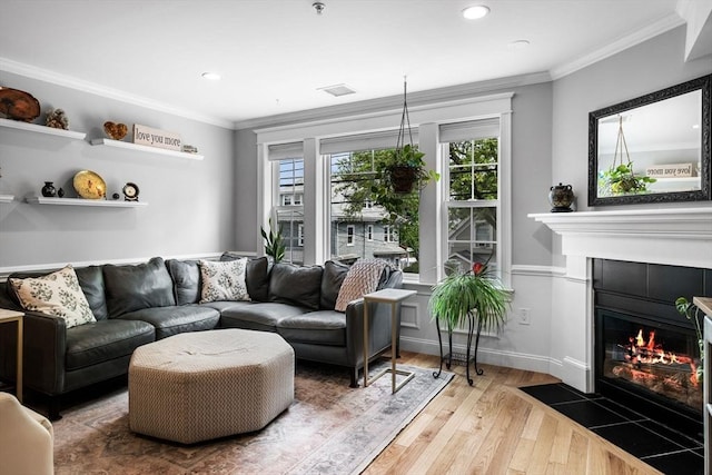 100 Burrill St Unit 3, Swampscott, MA 01907 - living area featuring a tile fireplace, wood finished floors, crown molding, and recessed lighting