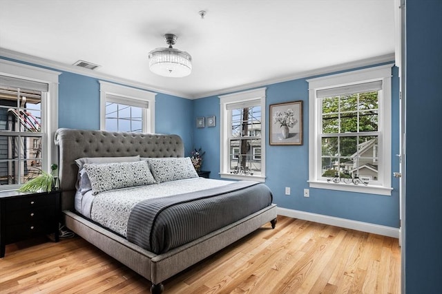 100 Burrill St Unit 3, Swampscott, MA 01907 - bedroom with baseboards, multiple windows, light wood finished floors, and crown molding