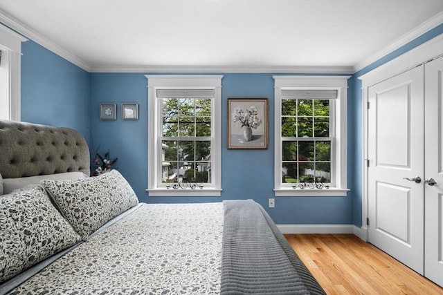 100 Burrill St Unit 3, Swampscott, MA 01907 - bedroom with multiple windows, baseboards, wood finished floors, crown molding, and a closet