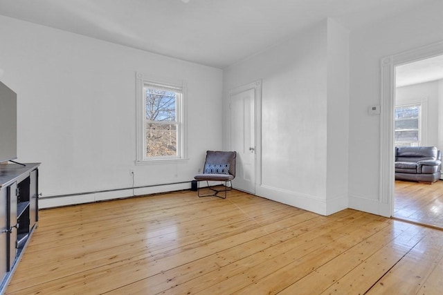 201 High St, Brookline, MA 02445 - unfurnished room with hardwood / wood-style floors, a baseboard radiator, and baseboards