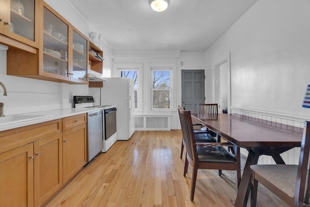201 High St, Brookline, MA 02445 - kitchen featuring range with electric cooktop, a sink, light wood-style flooring, stainless steel dishwasher, and glass insert cabinets