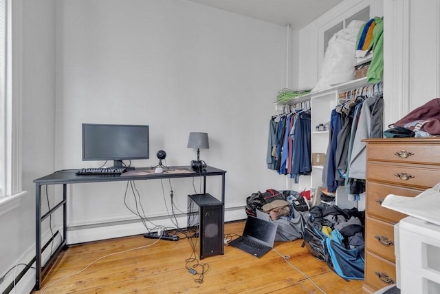 201 High St, Brookline, MA 02445 - office area featuring wood finished floors and a baseboard heating unit
