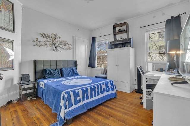 201 High St, Brookline, MA 02445 - bedroom with hardwood / wood-style flooring, multiple windows, a desk, and baseboards