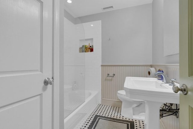 201 High St, Brookline, MA 02445 - bathroom with toilet, wainscoting, tile patterned flooring, and shower / bathtub combination