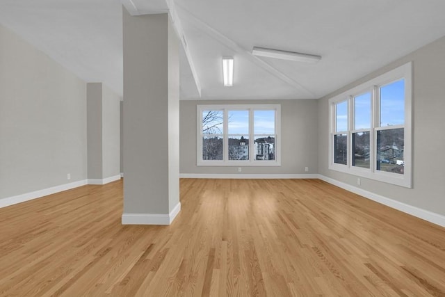 201 High St, Brookline, MA 02445 - unfurnished living room featuring light wood-type flooring, baseboards, and vaulted ceiling