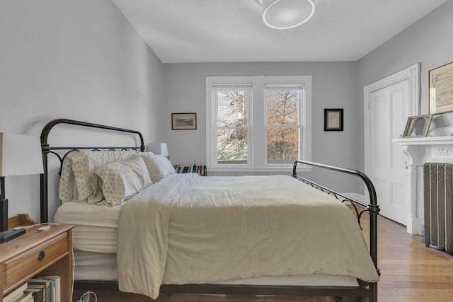 201 High St, Brookline, MA 02445 - bedroom featuring wood finished floors and radiator heating unit