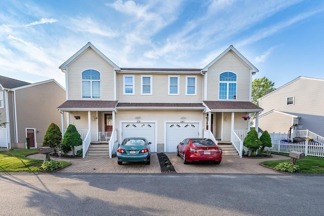 578-580 Detroit St, Fall River, MA 02721 - townhome / multi-family property featuring covered porch, driveway, and an attached garage