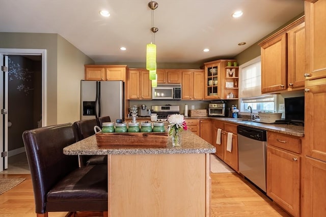 578-580 Detroit St, Fall River, MA 02721 - kitchen with appliances with stainless steel finishes, open shelves, a sink, a kitchen island, and light wood-style flooring