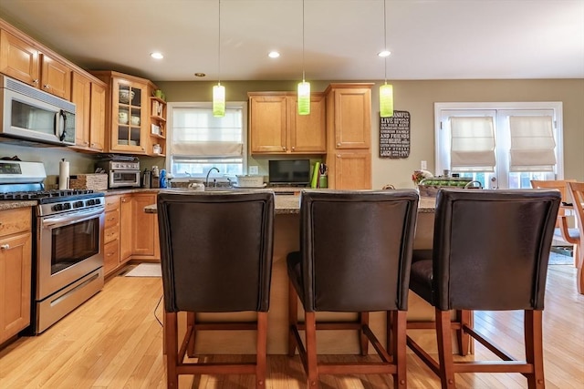 578-580 Detroit St, Fall River, MA 02721 - kitchen with appliances with stainless steel finishes, light wood finished floors, dark stone countertops, a center island, and recessed lighting