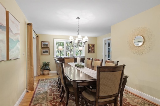 62 Waite Rd, Boxborough, MA 01719 - dining area featuring a chandelier, baseboards, and light wood-type flooring