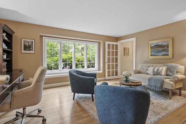 62 Waite Rd, Boxborough, MA 01719 - living room with a desk, light wood-style flooring, and baseboards