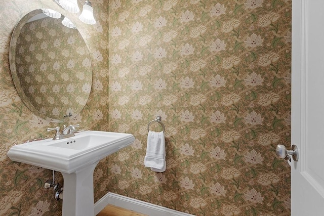 62 Waite Rd, Boxborough, MA 01719 - bathroom featuring wallpapered walls, a sink, and baseboards