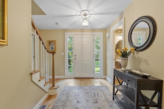 62 Waite Rd, Boxborough, MA 01719 - entrance foyer featuring baseboards, light wood-style floors, and stairway