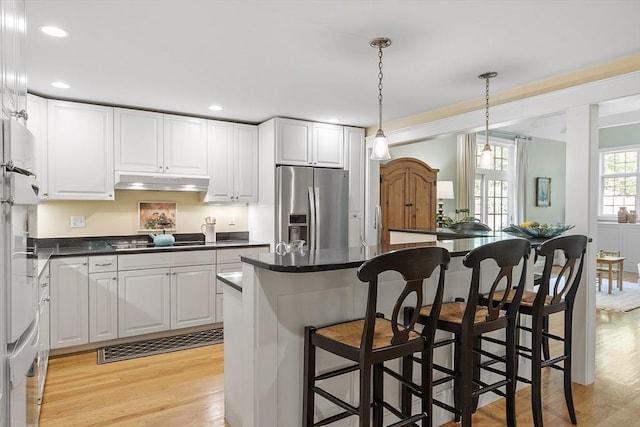 62 Waite Rd, Boxborough, MA 01719 - kitchen featuring stainless steel refrigerator with ice dispenser, light wood-style flooring, white cabinetry, black electric cooktop, and a kitchen bar