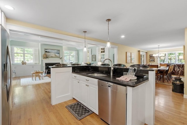 62 Waite Rd, Boxborough, MA 01719 - kitchen with stainless steel appliances, a sink, a fireplace, plenty of natural light, and recessed lighting
