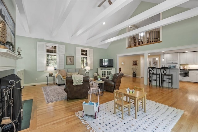 62 Waite Rd, Boxborough, MA 01719 - living area with a fireplace, baseboards, light wood-style flooring, beamed ceiling, and high vaulted ceiling