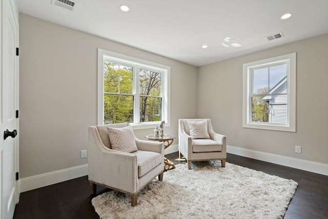 sitting room with visible vents, baseboards, and a wealth of natural light