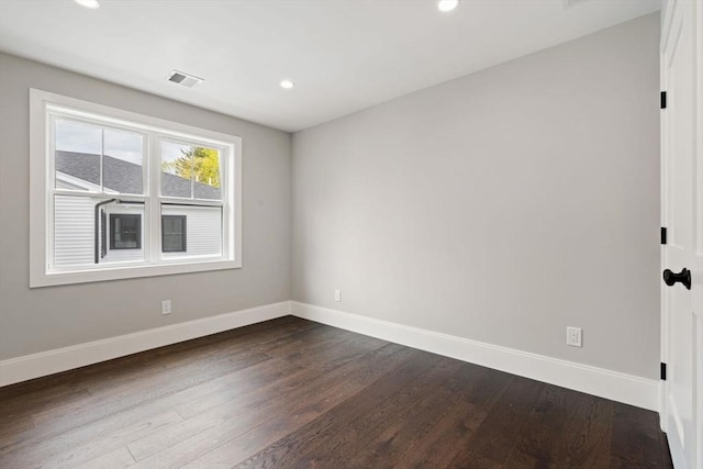 empty room with recessed lighting, baseboards, visible vents, and dark wood-style floors