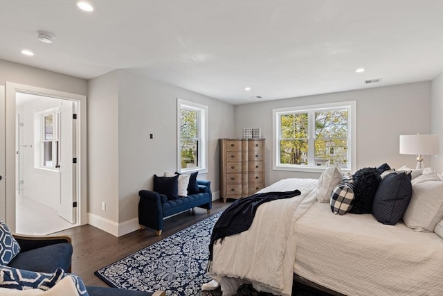 bedroom featuring baseboards, multiple windows, recessed lighting, and wood finished floors