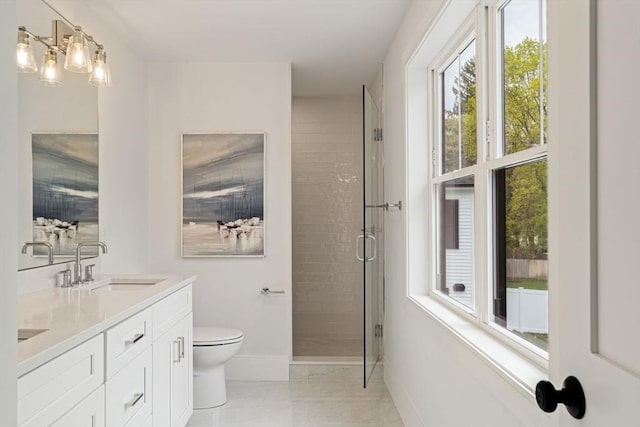 full bathroom featuring double vanity, toilet, baseboards, a shower stall, and a sink
