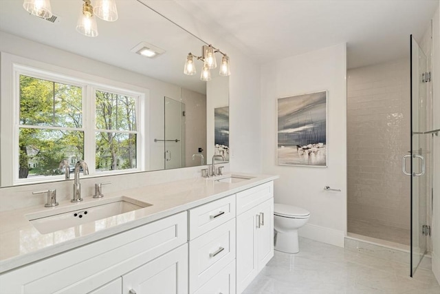 bathroom with a sink, marble finish floor, toilet, and a shower stall