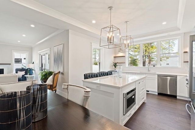 kitchen with an inviting chandelier, recessed lighting, white cabinetry, and appliances with stainless steel finishes