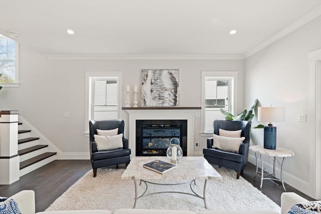 living room featuring a healthy amount of sunlight, baseboards, and wood finished floors