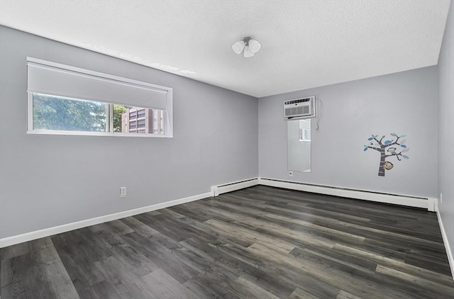 64 Main St Unit 25B, Stoneham, MA 02180 - spare room featuring a baseboard heating unit, dark wood-type flooring, a textured ceiling, and a wall unit AC