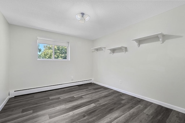64 Main St Unit 25B, Stoneham, MA 02180 - unfurnished room with a baseboard heating unit, dark wood-style flooring, and a textured ceiling