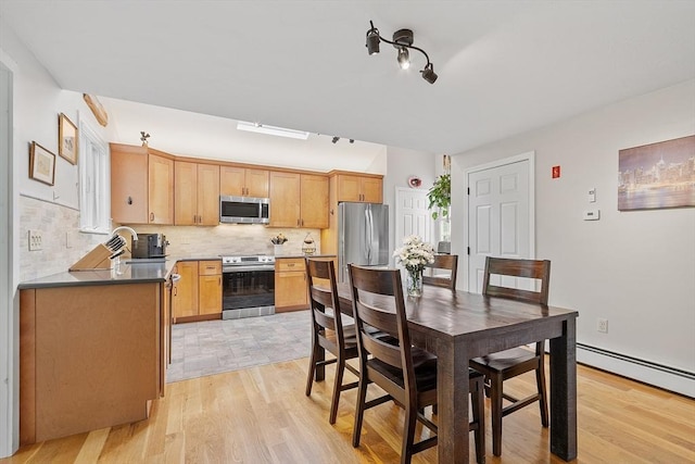 17 Lantern Ln, Leominster, MA 01453 - dining space featuring light wood finished floors and a baseboard radiator