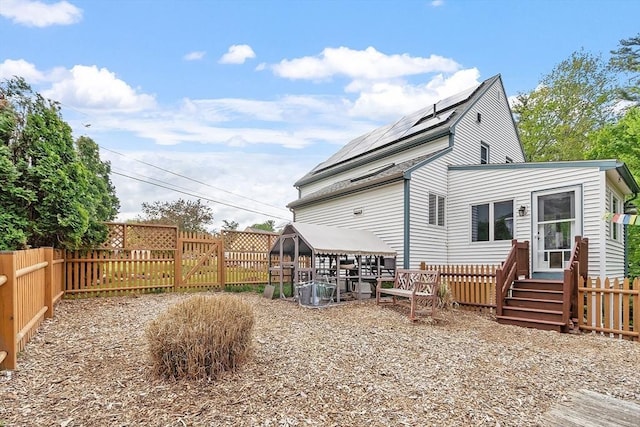 17 Lantern Ln, Leominster, MA 01453 - back of house with a fenced backyard and roof mounted solar panels