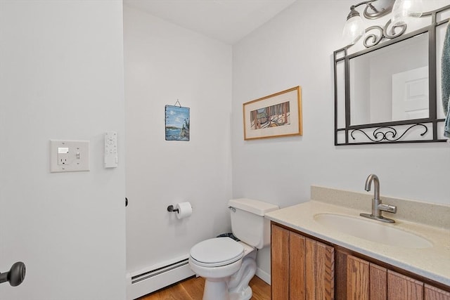17 Lantern Ln, Leominster, MA 01453 - bathroom featuring baseboard heating, toilet, vanity, and wood finished floors