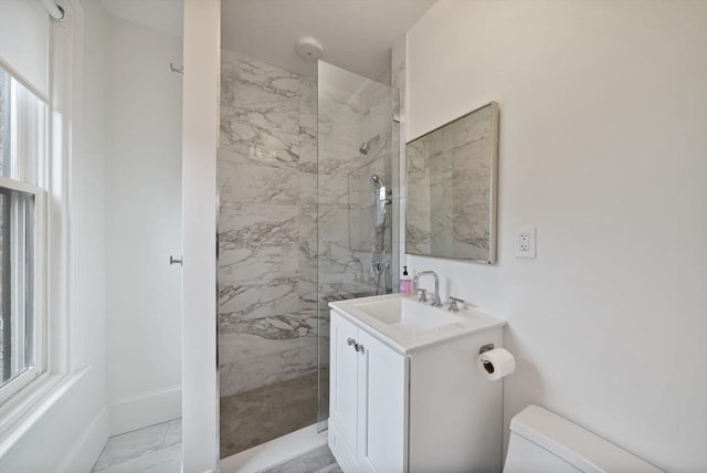 full bathroom with toilet, vanity, baseboards, marble finish floor, and a marble finish shower