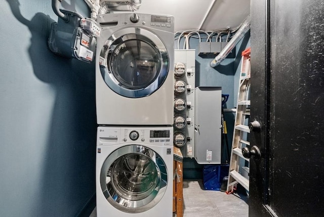 laundry area featuring stacked washer / drying machine and laundry area