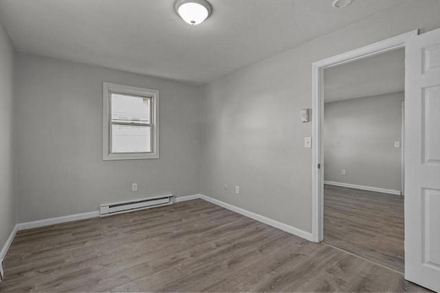 empty room featuring light hardwood / wood-style floors and baseboard heating