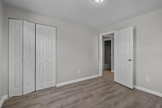 unfurnished bedroom with light hardwood / wood-style flooring and a closet