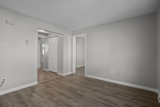 empty room featuring dark wood-type flooring