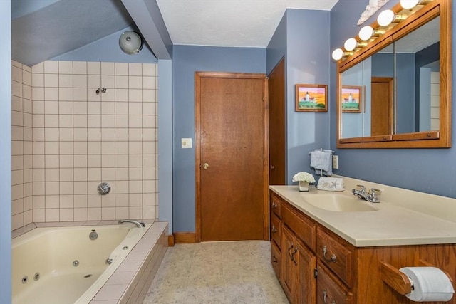 full bath with vanity and baseboards