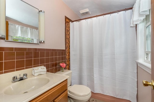 bathroom featuring toilet, tile walls, a shower with curtain, and vanity