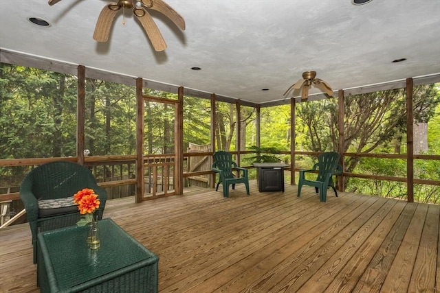 sunroom / solarium with a ceiling fan