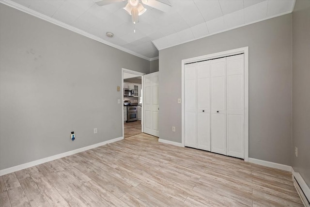 30 Whipple St, Worcester, MA 01607 - unfurnished bedroom featuring crown molding, light wood finished floors, baseboard heating, a closet, and ceiling fan