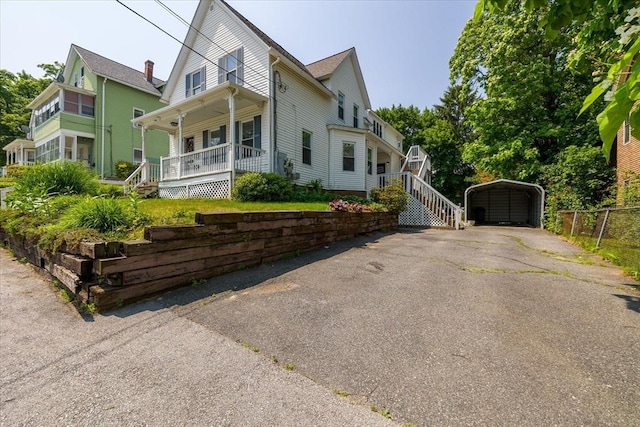 30 Whipple St, Worcester, MA 01607 - view of front of property featuring covered porch, a detached carport, and stairway