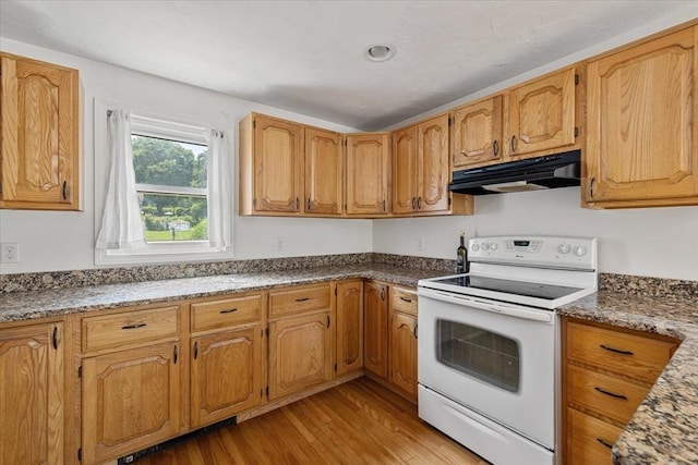 30 Whipple St, Worcester, MA 01607 - kitchen featuring white electric range oven, under cabinet range hood, light wood-style flooring, and brown cabinetry