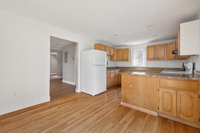 30 Whipple St, Worcester, MA 01607 - kitchen with freestanding refrigerator, a peninsula, light wood finished floors, stove, and electric panel