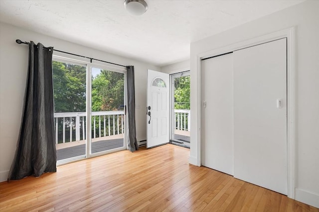 30 Whipple St, Worcester, MA 01607 - foyer entrance featuring light wood finished floors and a baseboard radiator