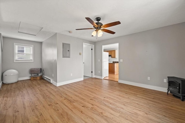 30 Whipple St, Worcester, MA 01607 - unfurnished living room featuring electric panel, a baseboard heating unit, a wood stove, attic access, and ceiling fan