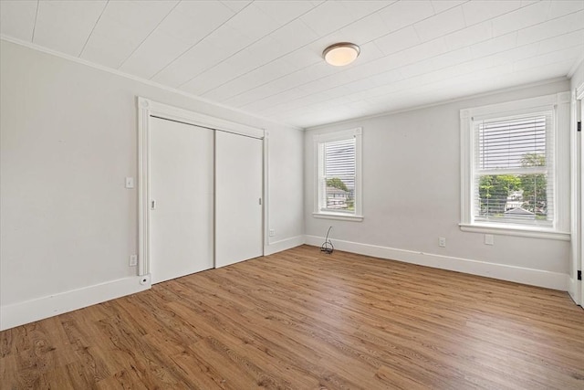 30 Whipple St, Worcester, MA 01607 - unfurnished bedroom featuring light wood finished floors, a closet, and ornamental molding